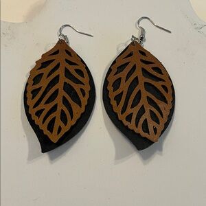 Laser cut leather leaf design on black suede background.
